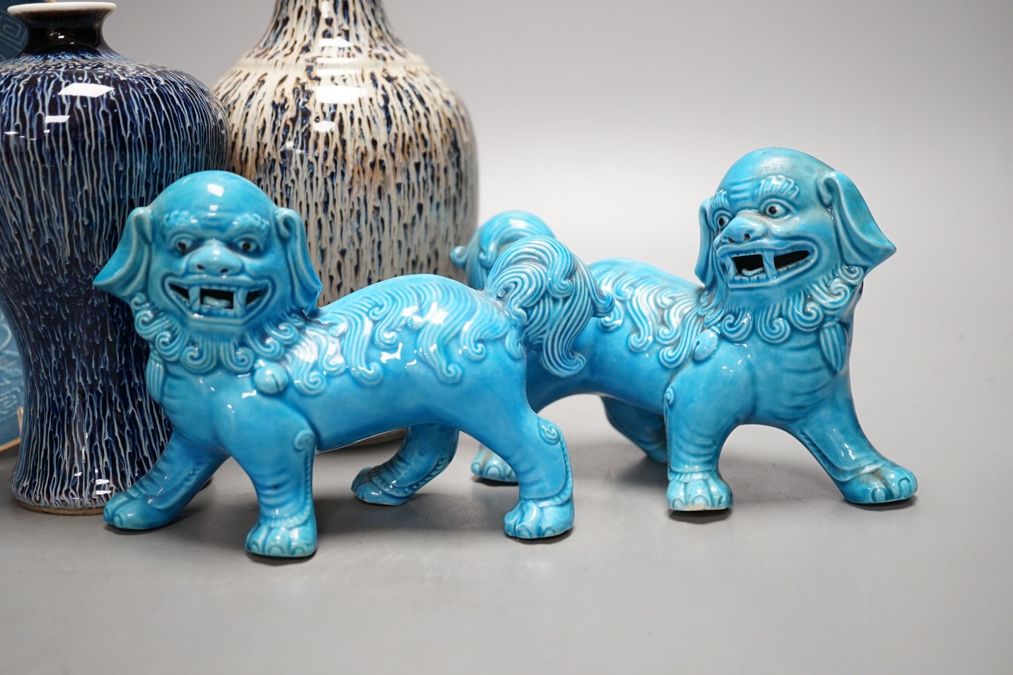 A pair of Chinese turquoise lion dogs, two flambe vases and a blue glazed dish, 25cm